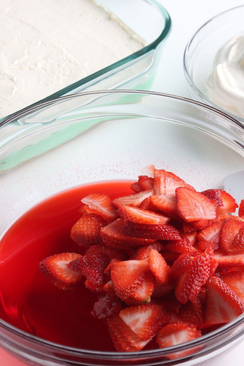 strawberries and jello in a glass bowl