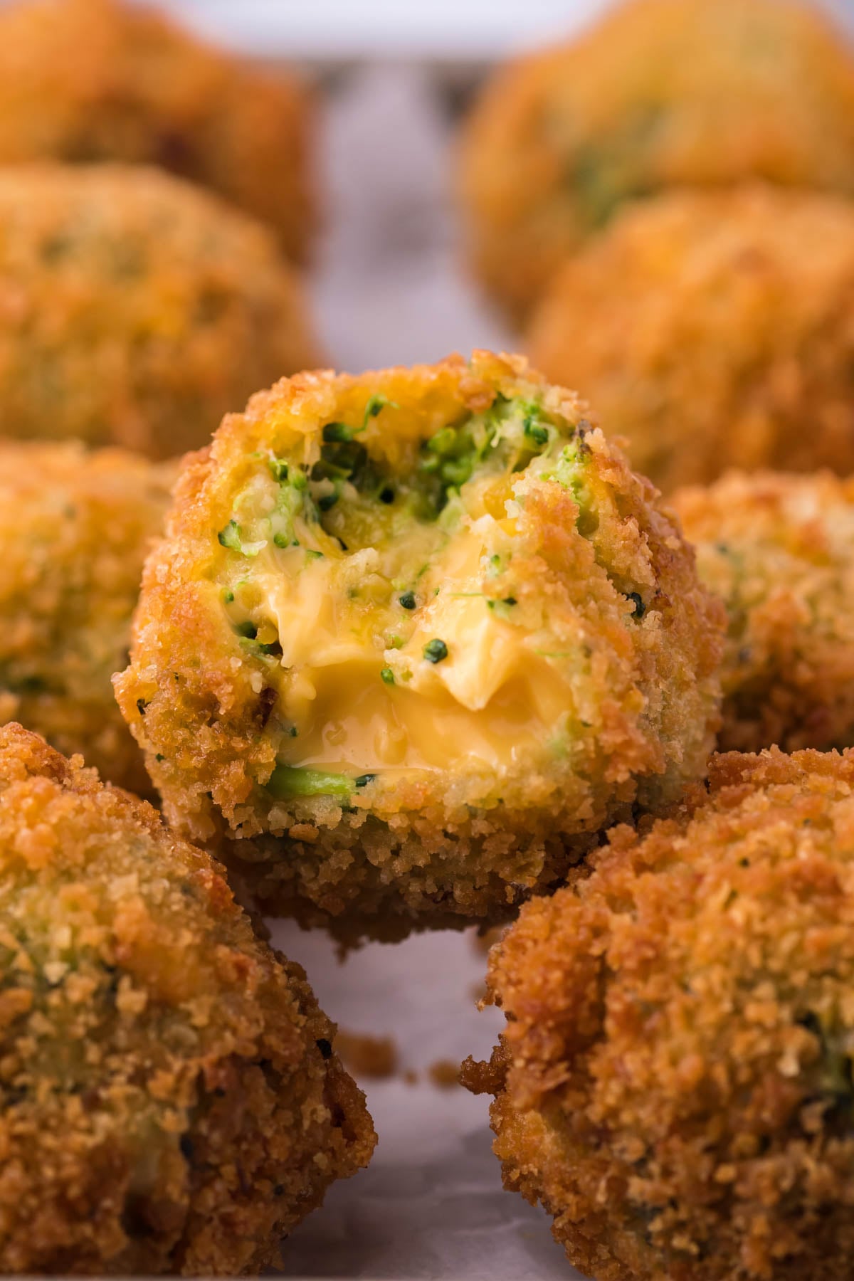 Broccoli Cheese Bites with a bite missing