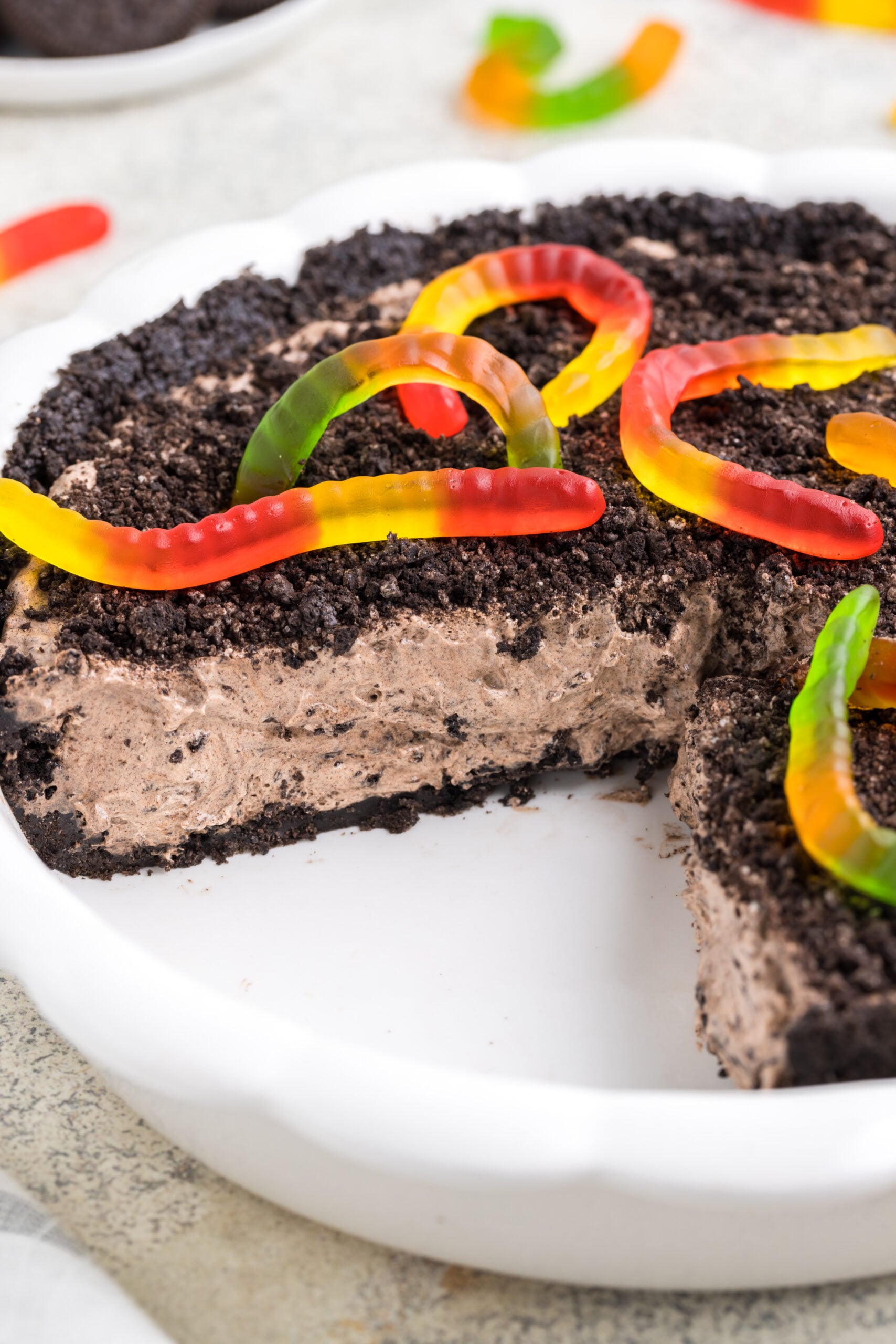 dirt pie in a white baking pan with a few slices cut out