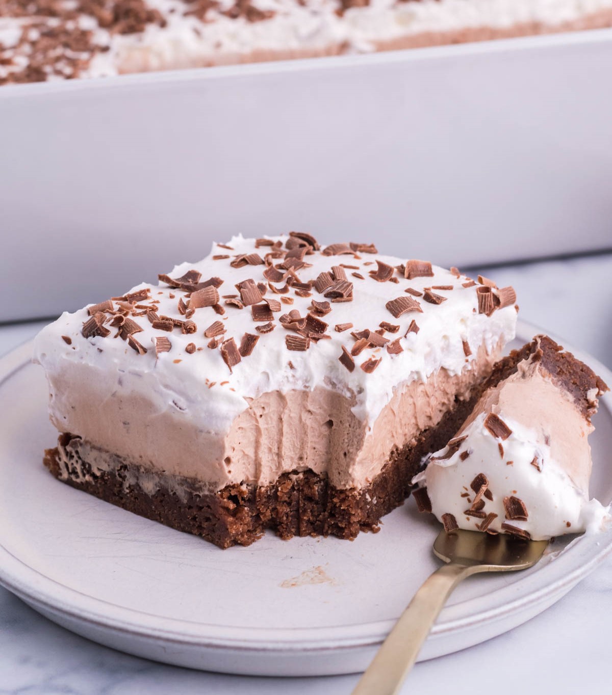 French Silk Brownies with fork bite taken out on a white plate