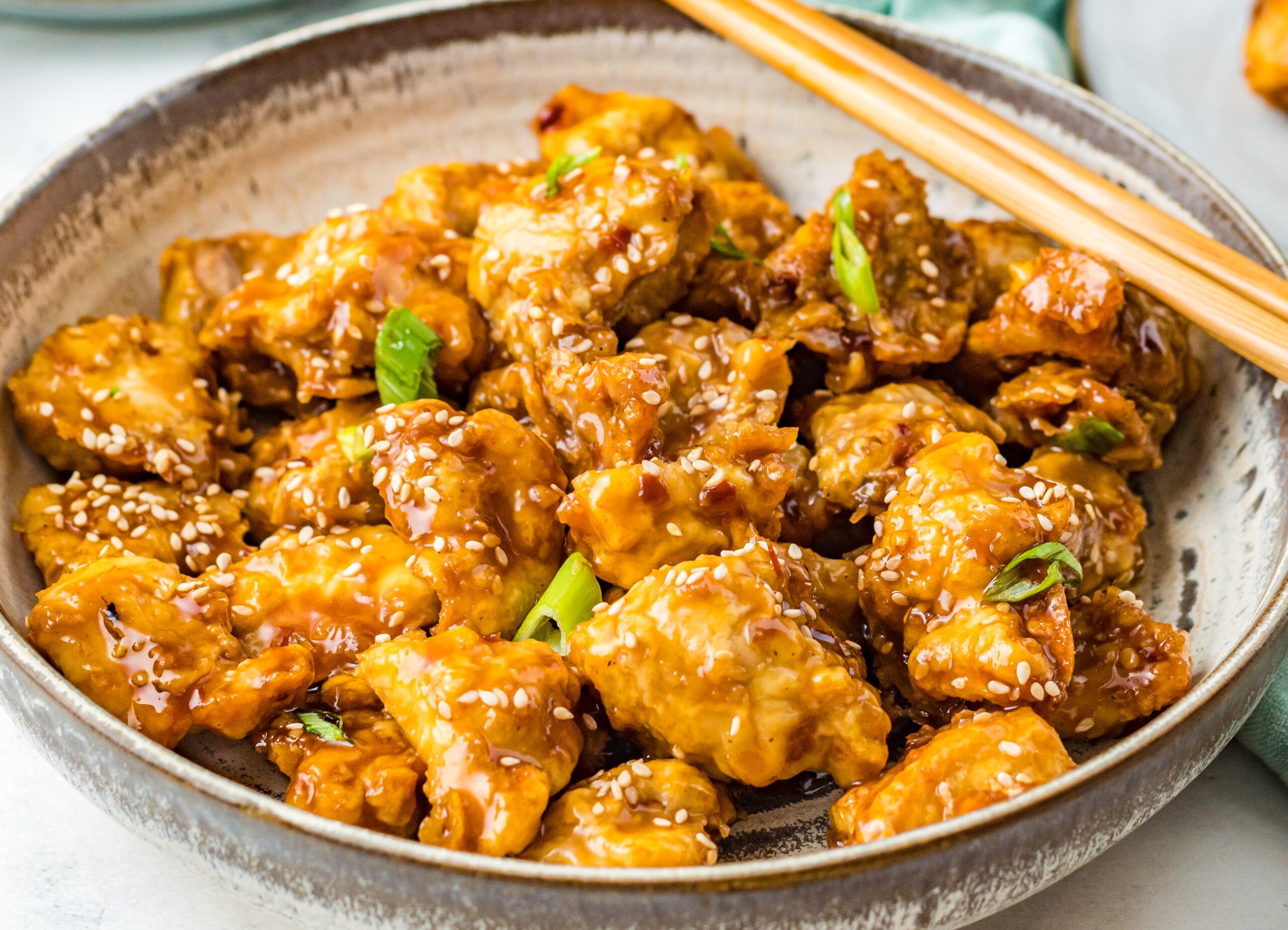 Close up view of Air Fryer General Tsos Chicken in a gray dish.