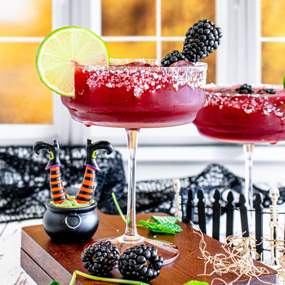 Sanderson Sisters Margaritas on table with Halloween decorations around it