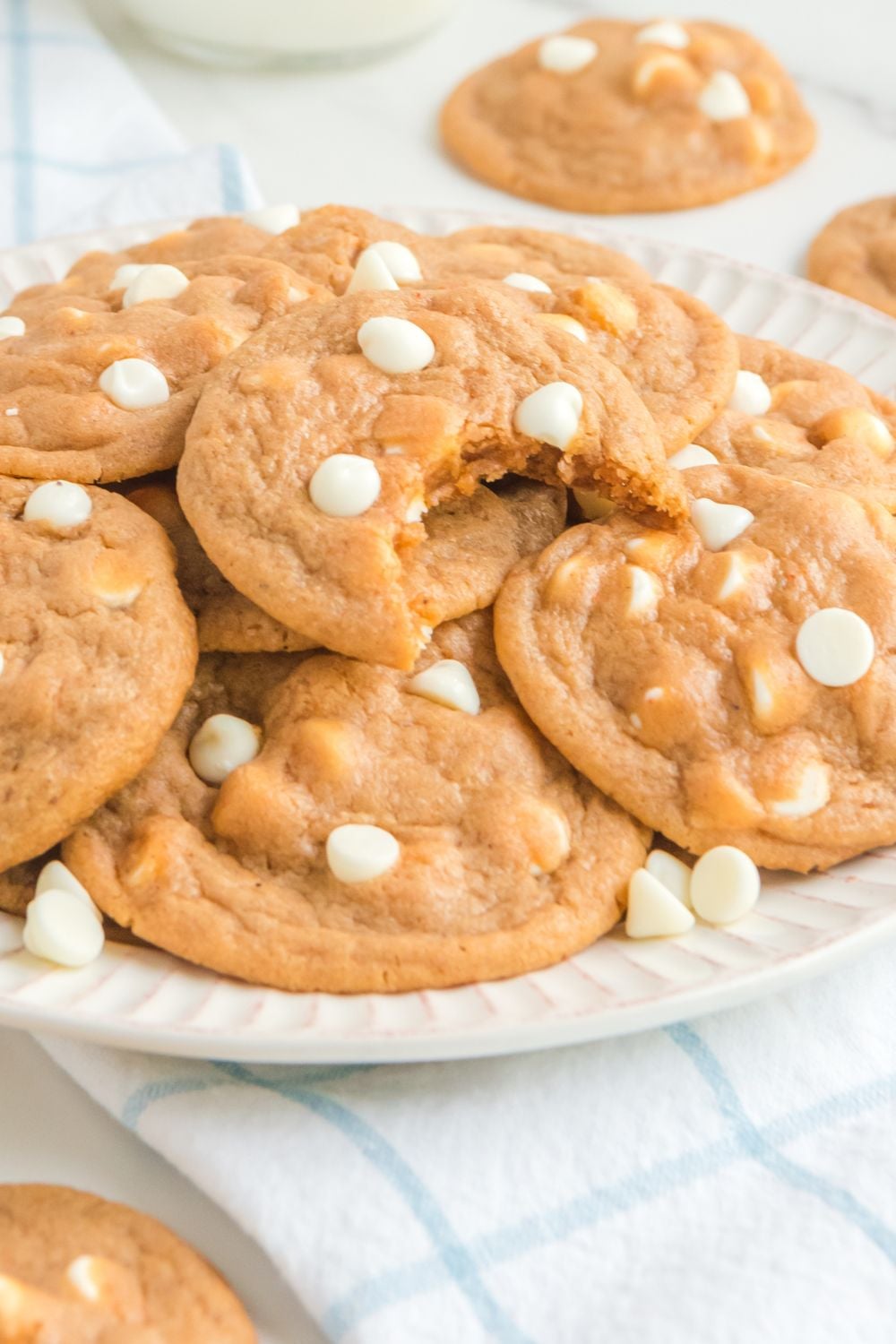 autumn cookies on a platter on table with cookies around it