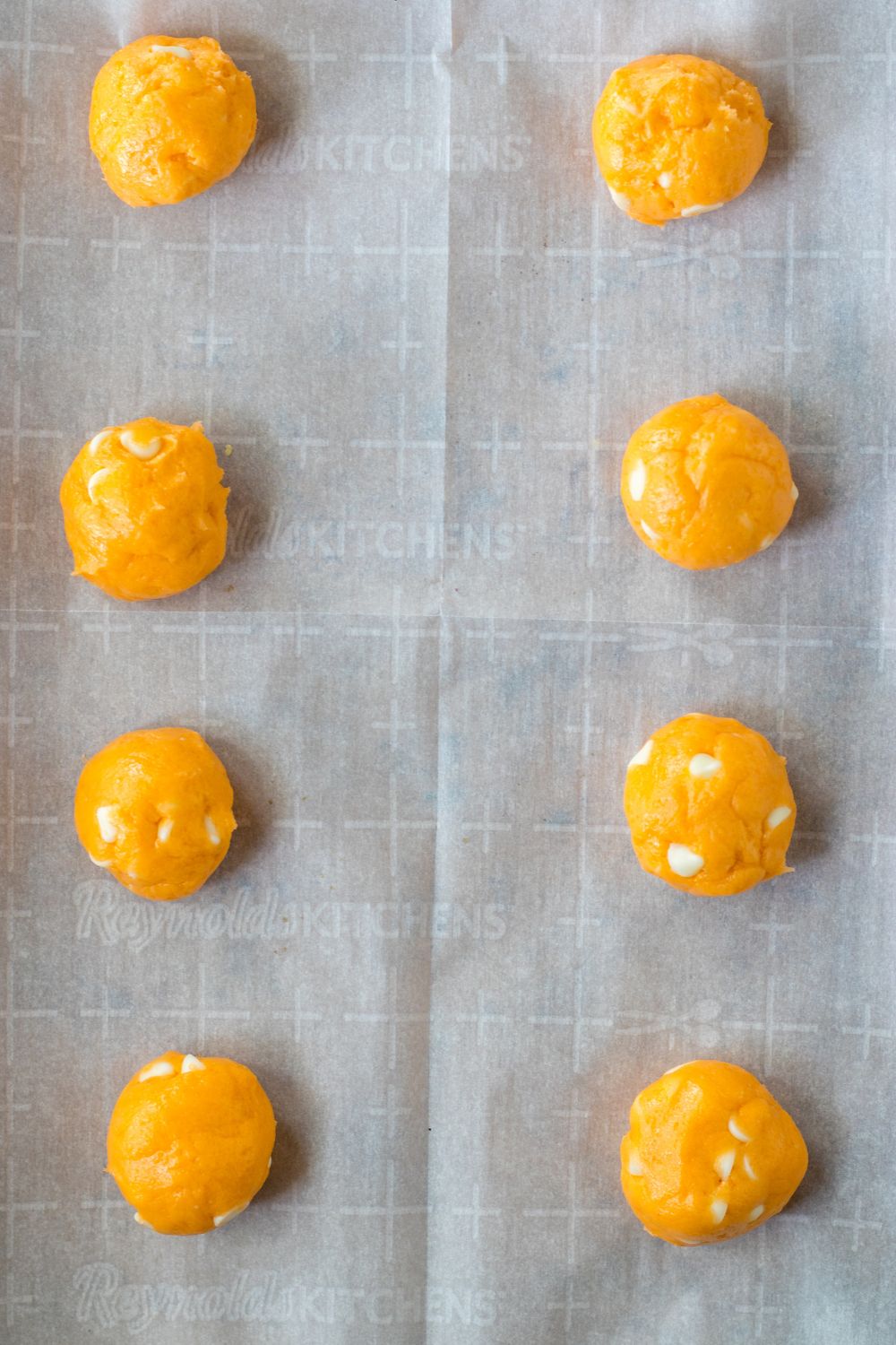 Orange Creamsicle Cookies rolled in balls on baking sheet 