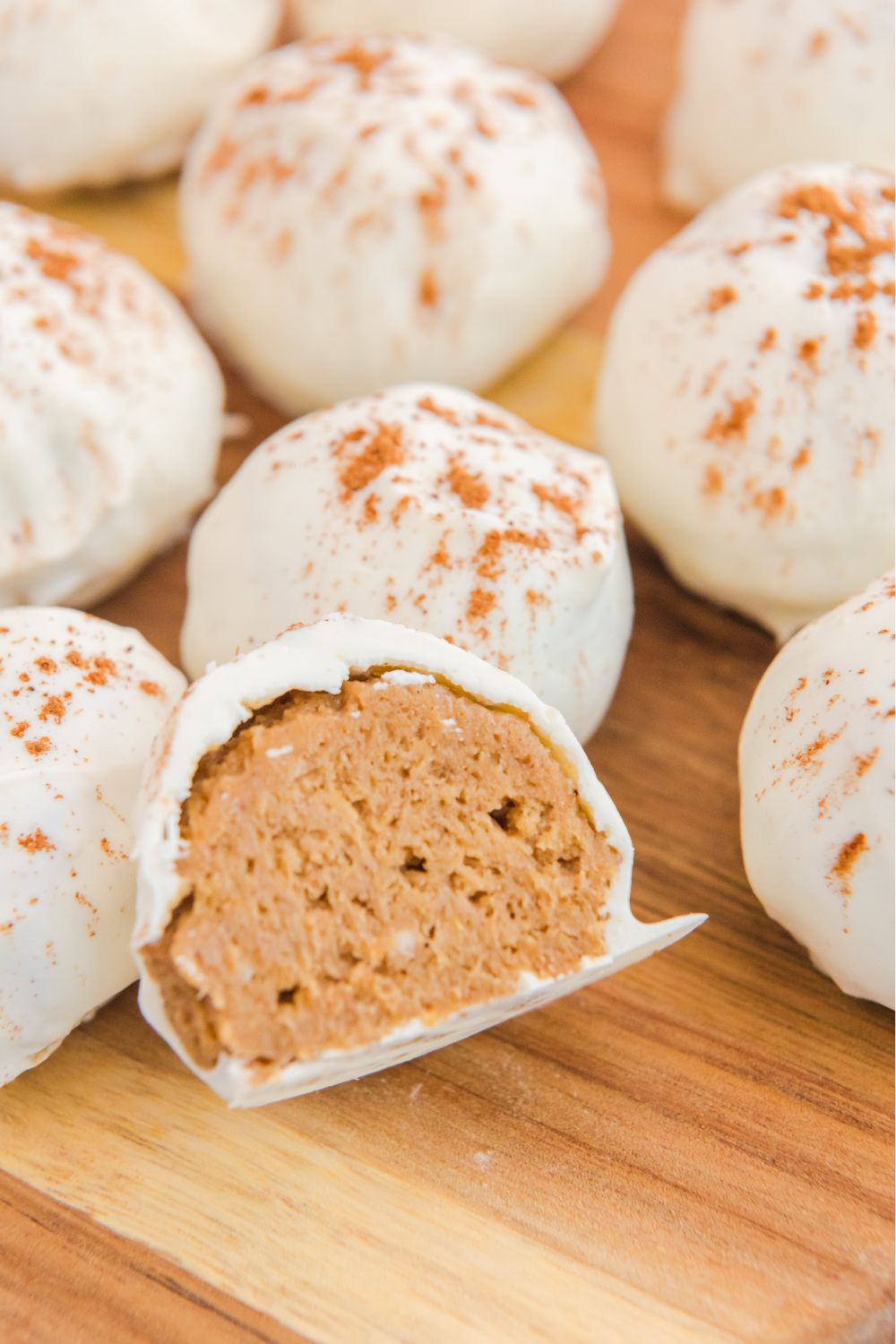 cheesecake balls with pumpkin on table with one sliced in half