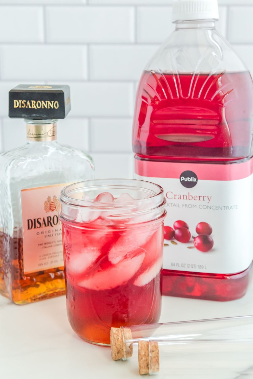 cranberry juice poured on top of disaronno in jar