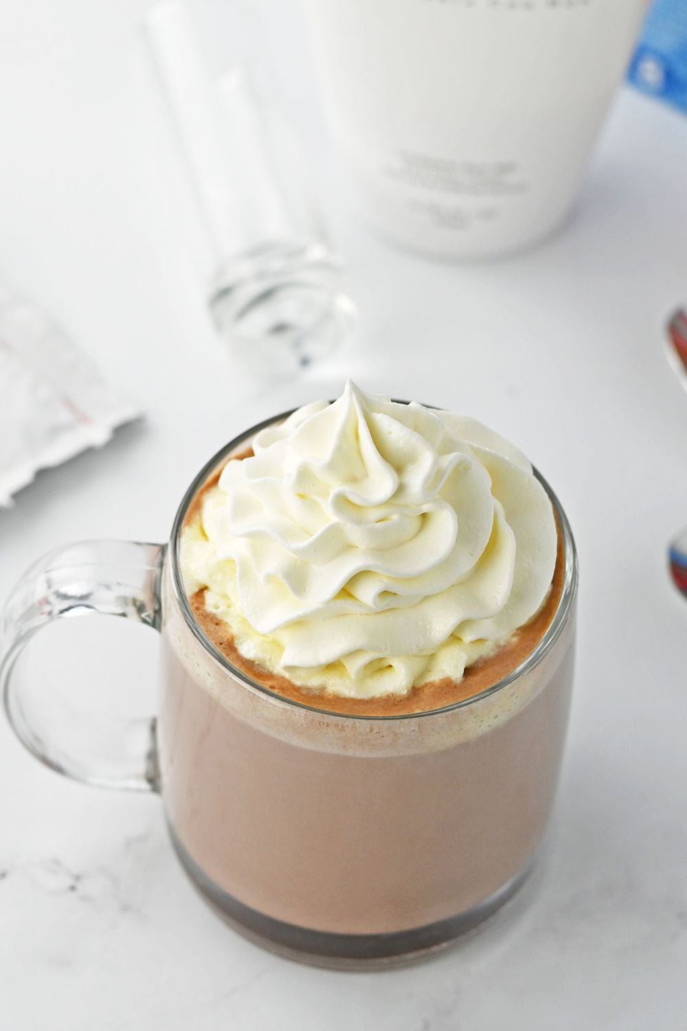 rumchata hot chocolate topped with whipped cream sitting on table