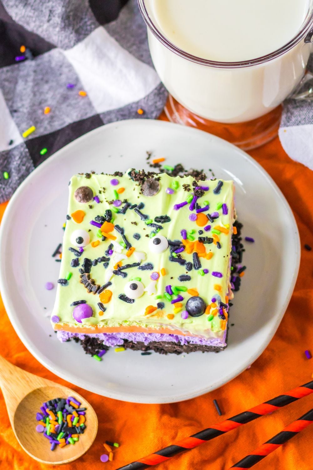 plate with a slice of halloween cake on it with sprinkles in plate on side 