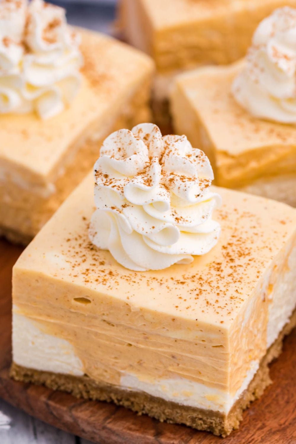 sliced pumpkin bars on a wooden cutting board