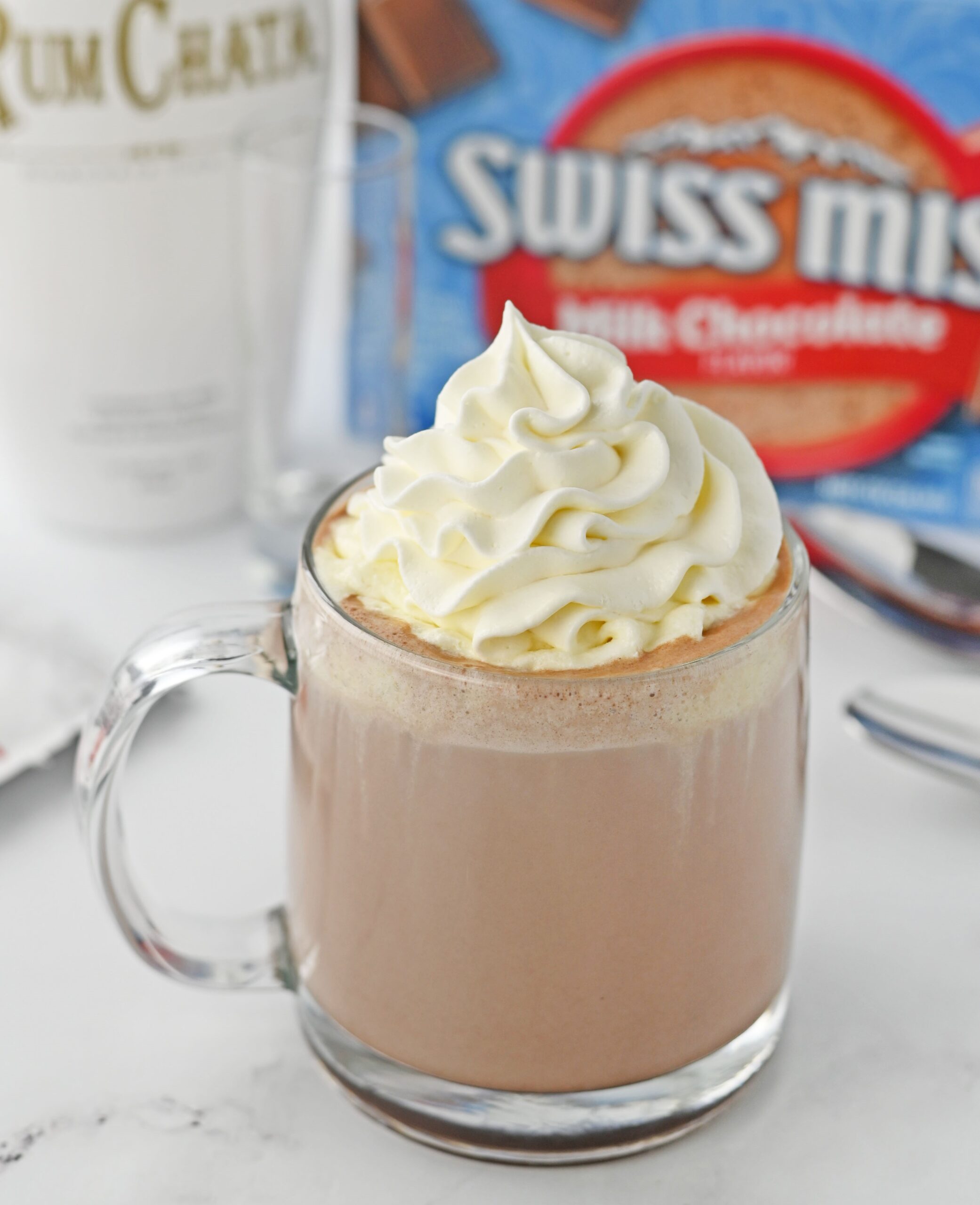 rumchata in a clear glass mug topped with whipped cream