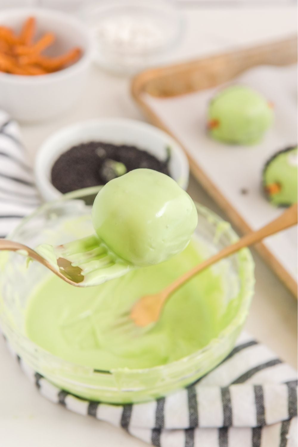 green dipped oreo ball in melted choclate