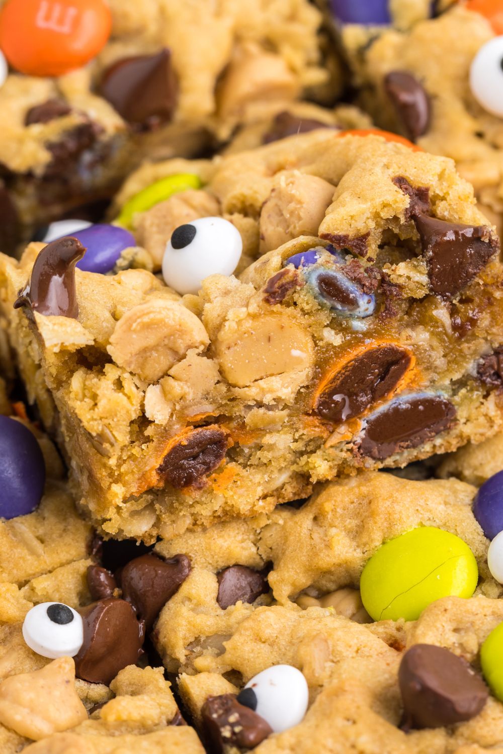 cookie bars stacked on top of each other on pan