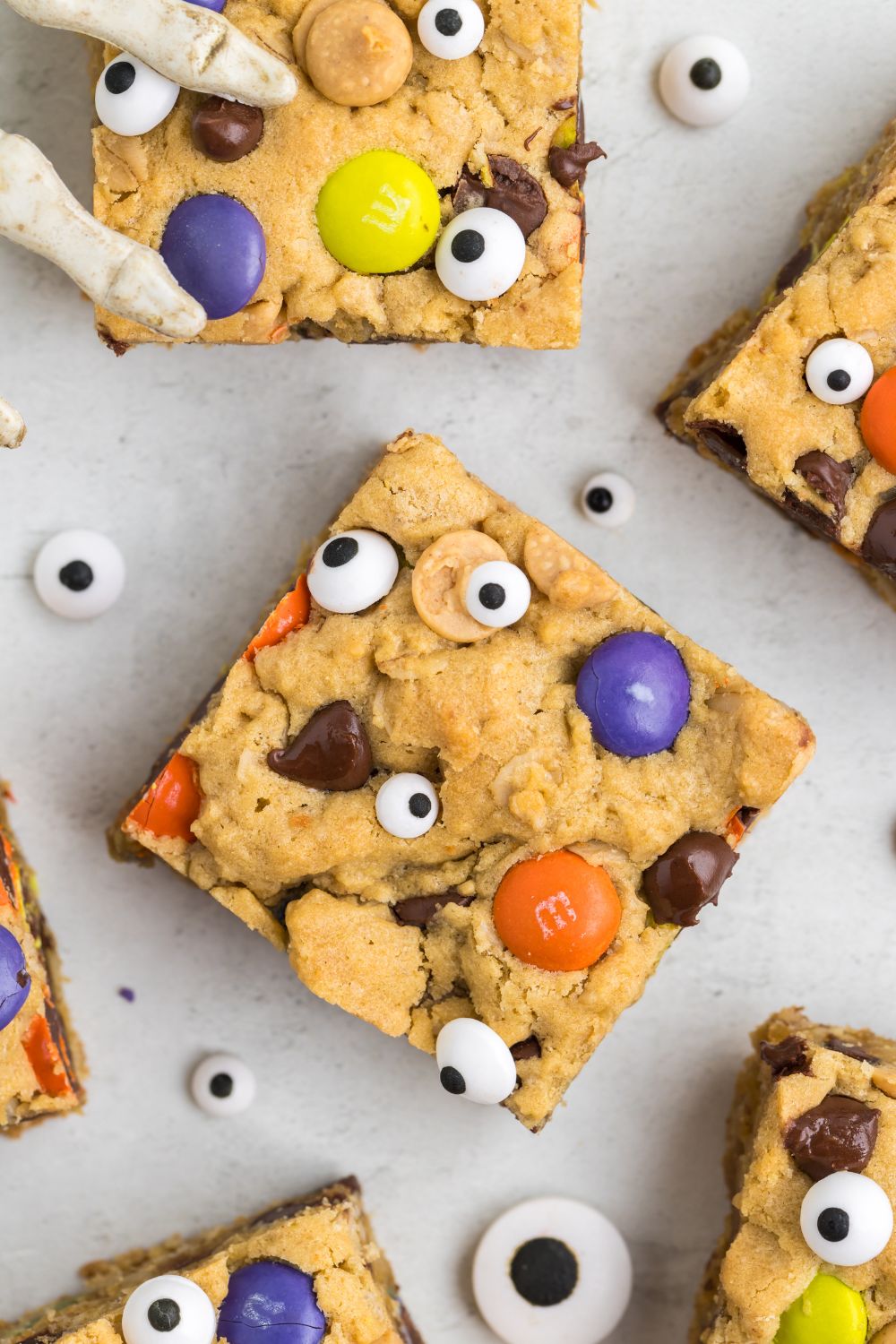 sliced cookie bars on table with candy eyes around it for Halloween