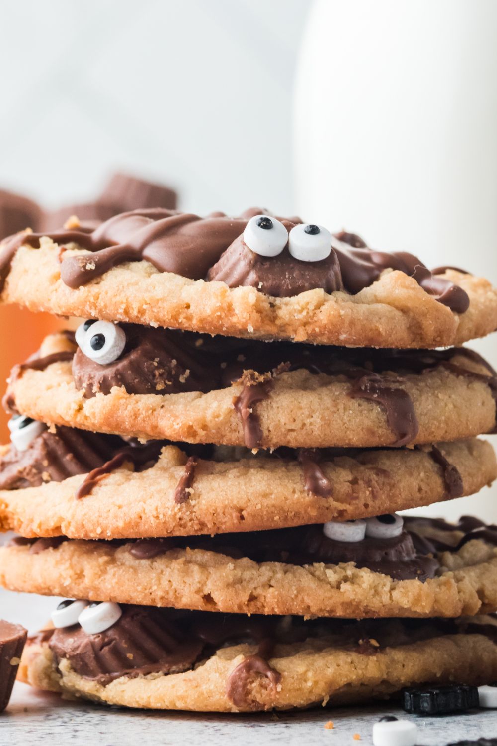 halloween cookies stacked on top of each other on table