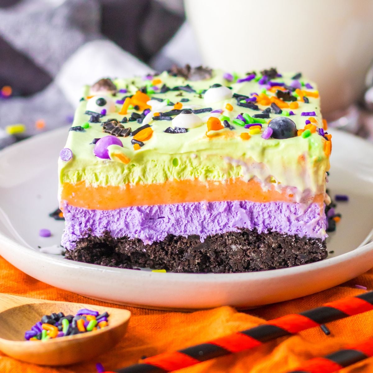 Halloween Lush Dessert sliced and placed on plate with sprinkles in a bowl on side