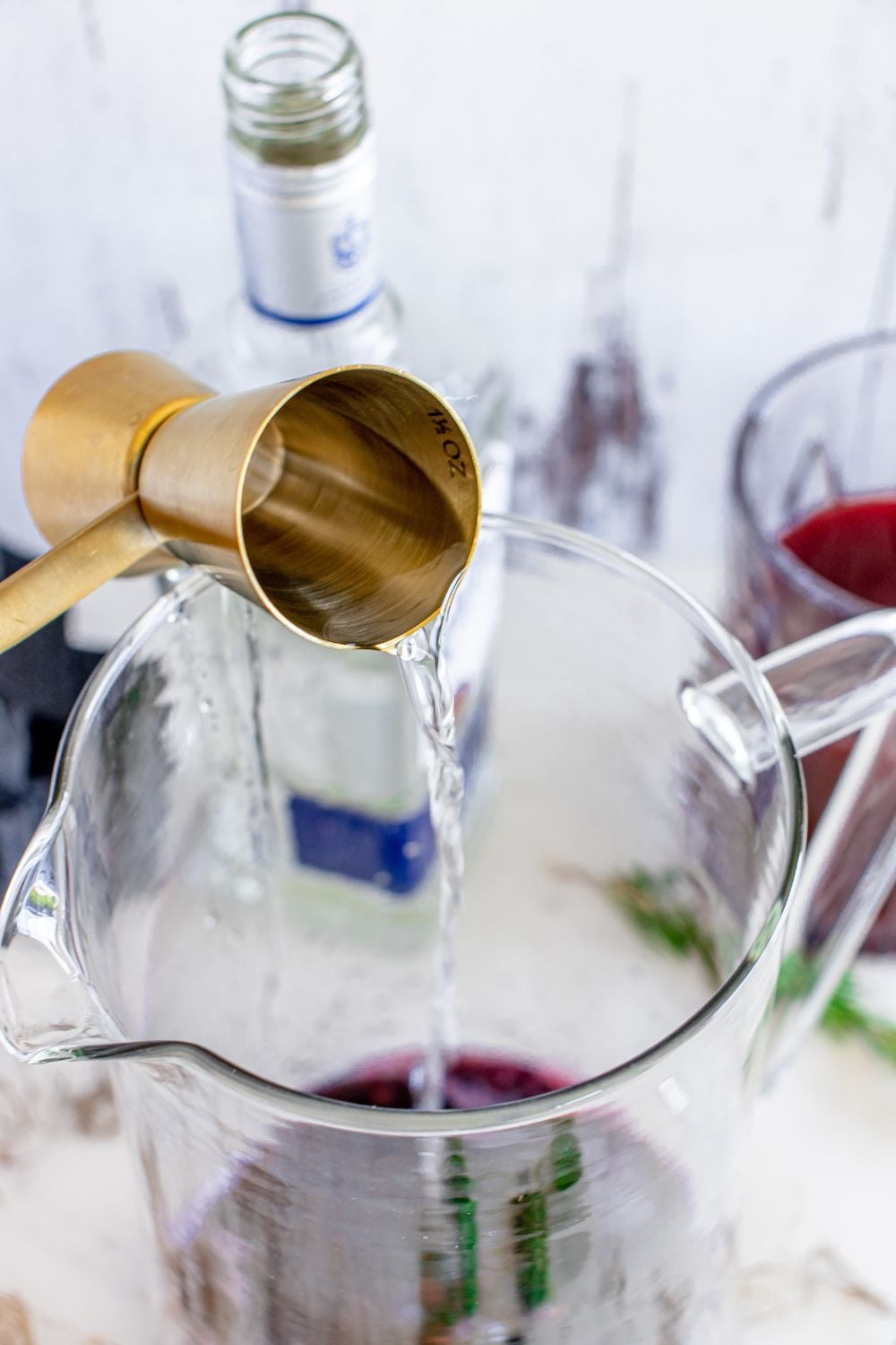 tequila pouring from shot glass into container
