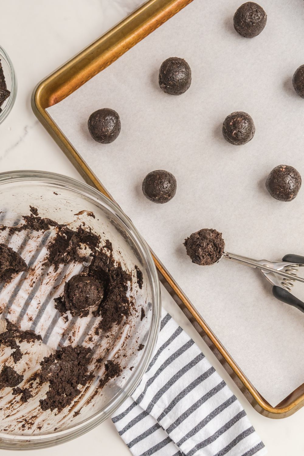 oreo balls on cookie sheet shaped in ball