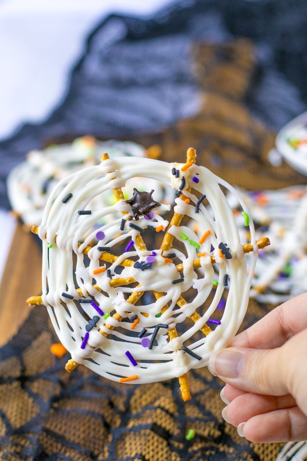 holding halloween pretzel in hand