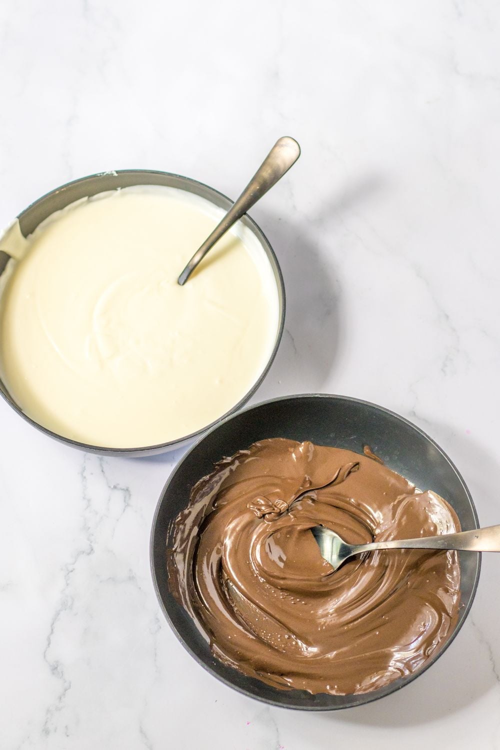 melted white and dark chocolate in bowl on table