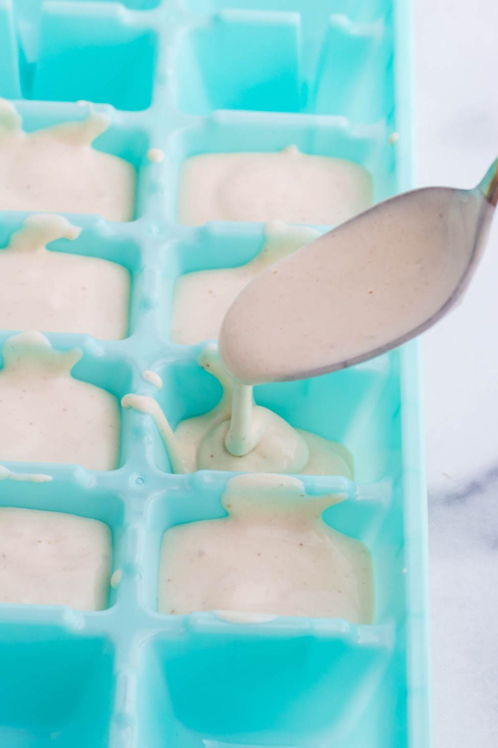 spooning dog ice cream into mold