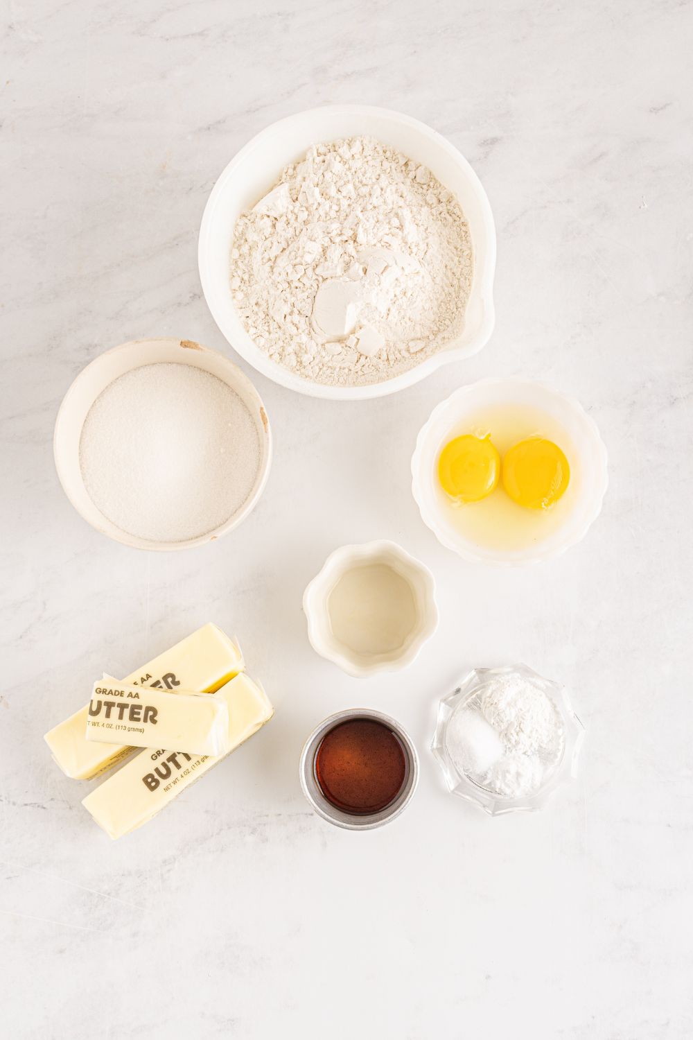 ingredients for sugar cookies on table in bowls