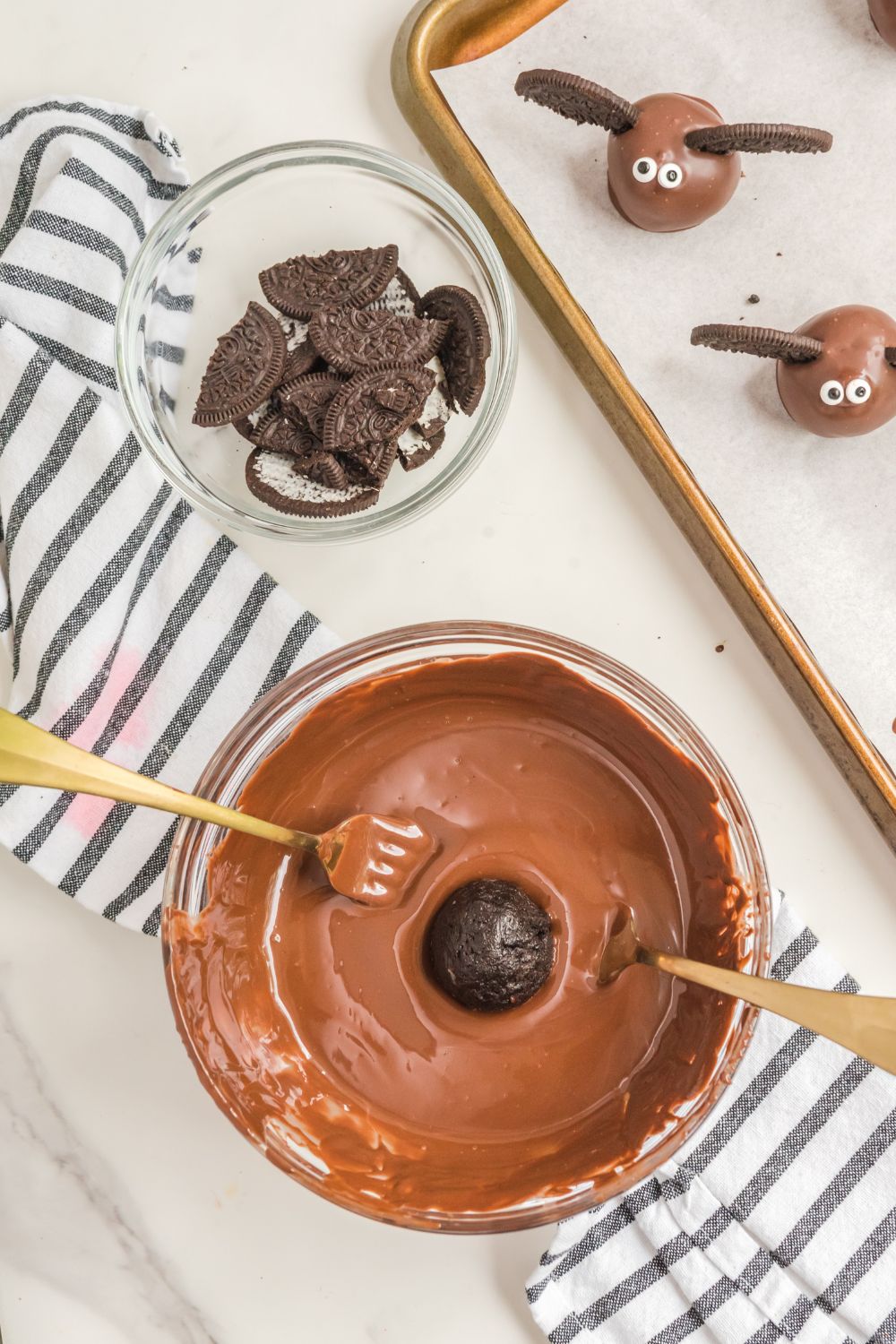 dipping Oreo ball in melted chocolate