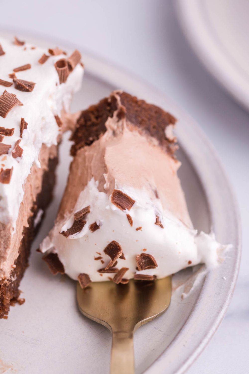 French silk pie with a fork bite taken out sitting on plate