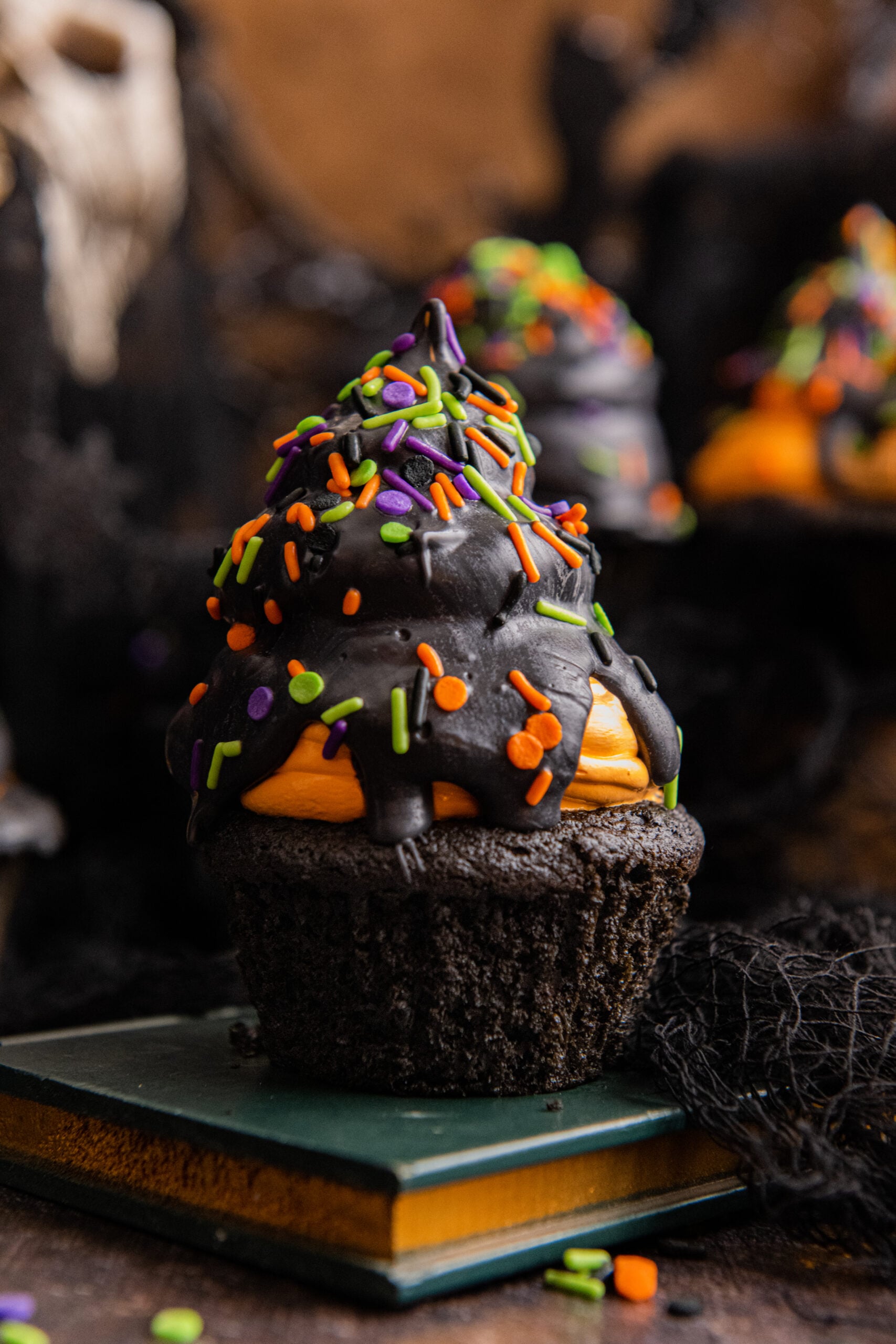 close up view of halloween cupcake on stacked books