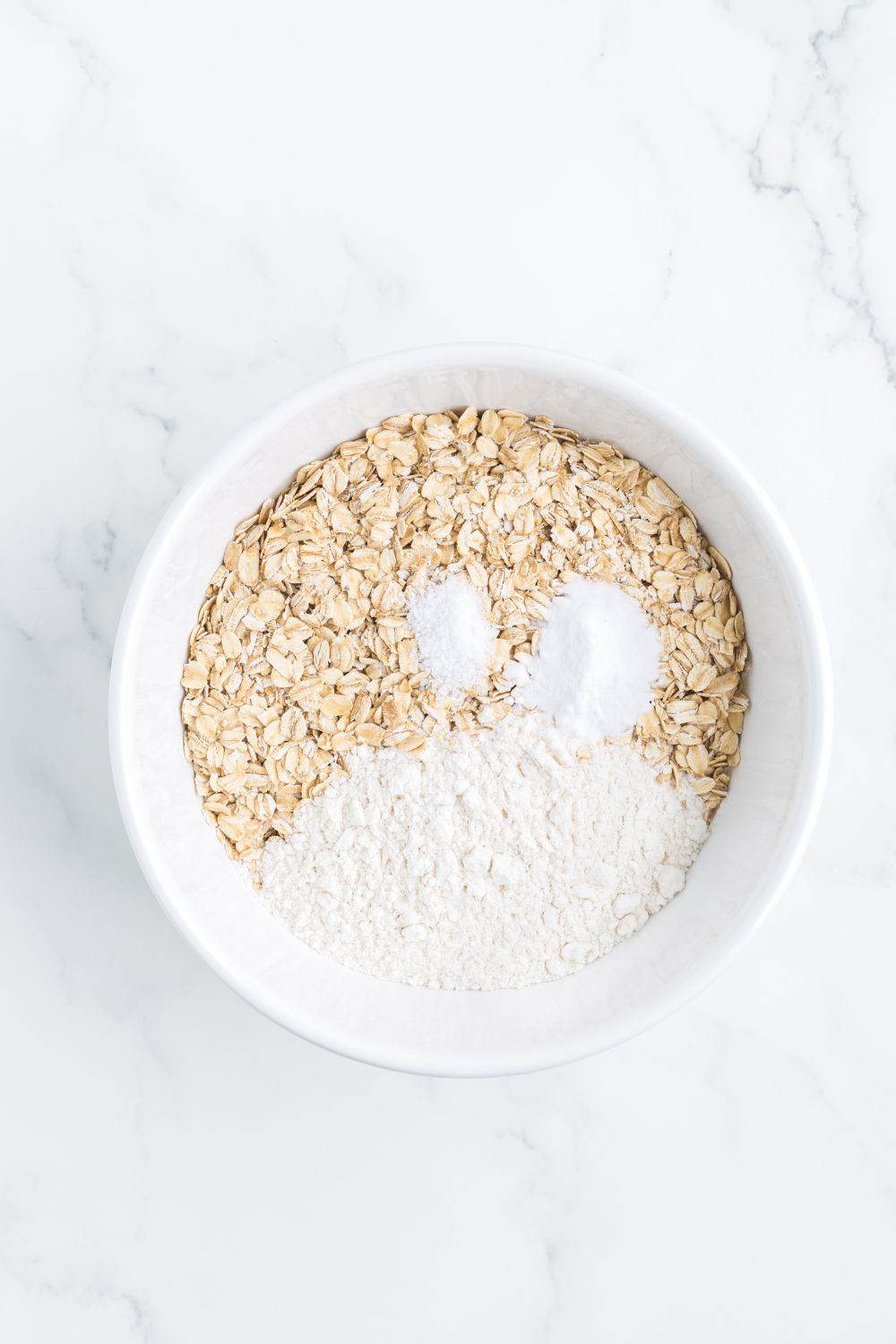 dry ingredients for cookies in a white bowl