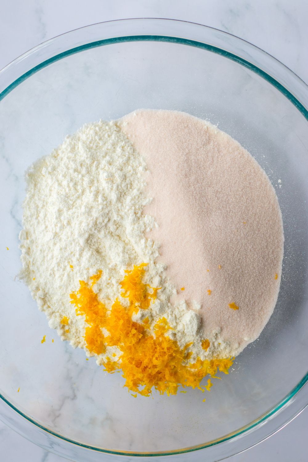 cake mix, orange zest and jello in a glass bowl