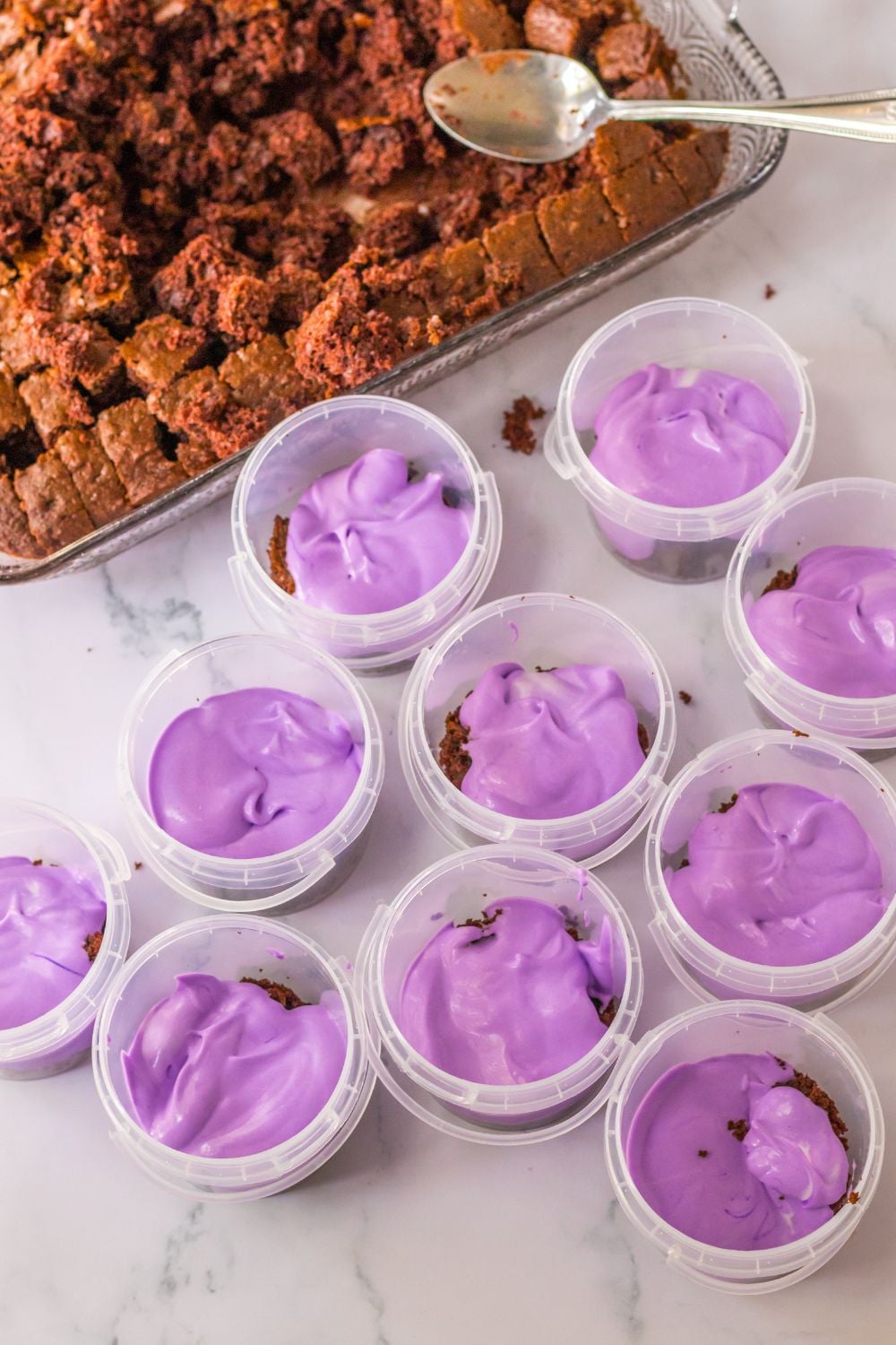 purple pudding in plastic containers on table