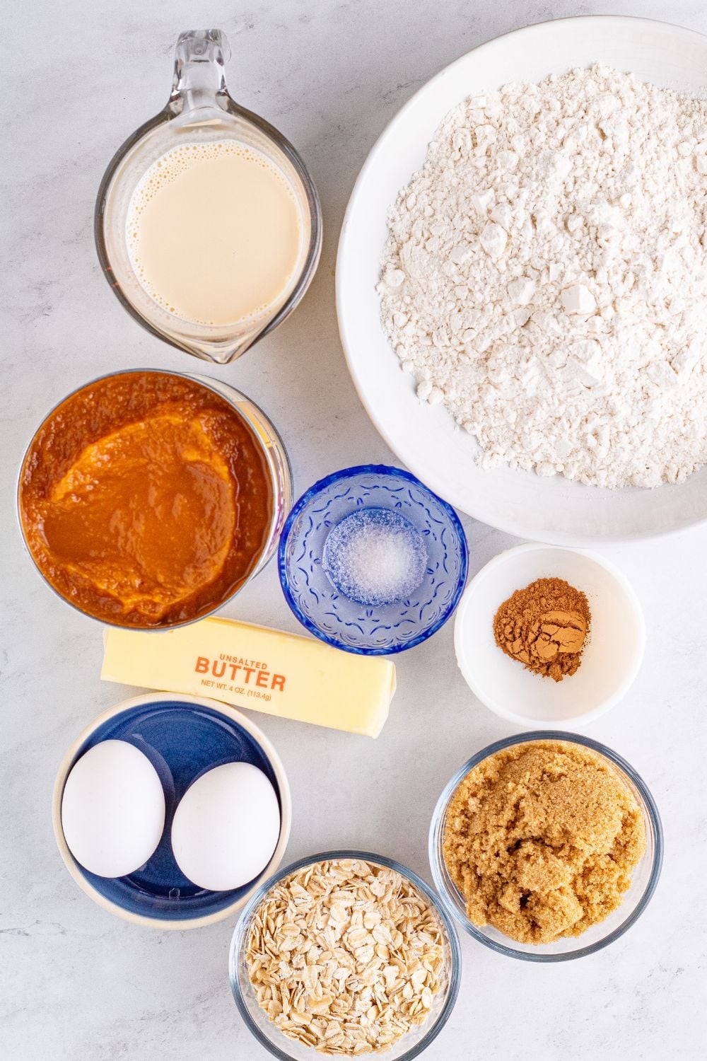 pumpkin dessert with all ingredients in bowl sitting on marble counter