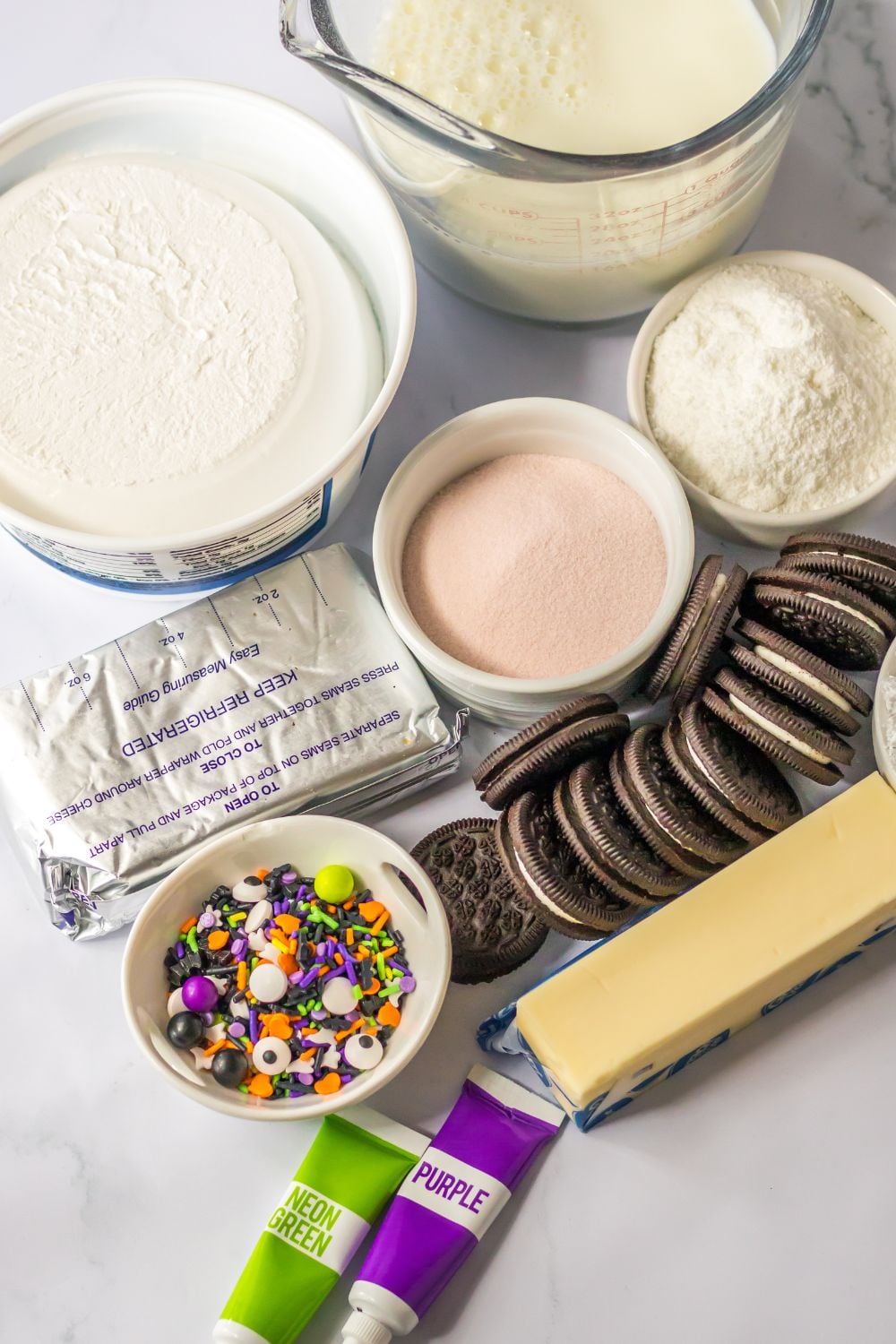 cream cheese layered dessert ingredients on a marble counter