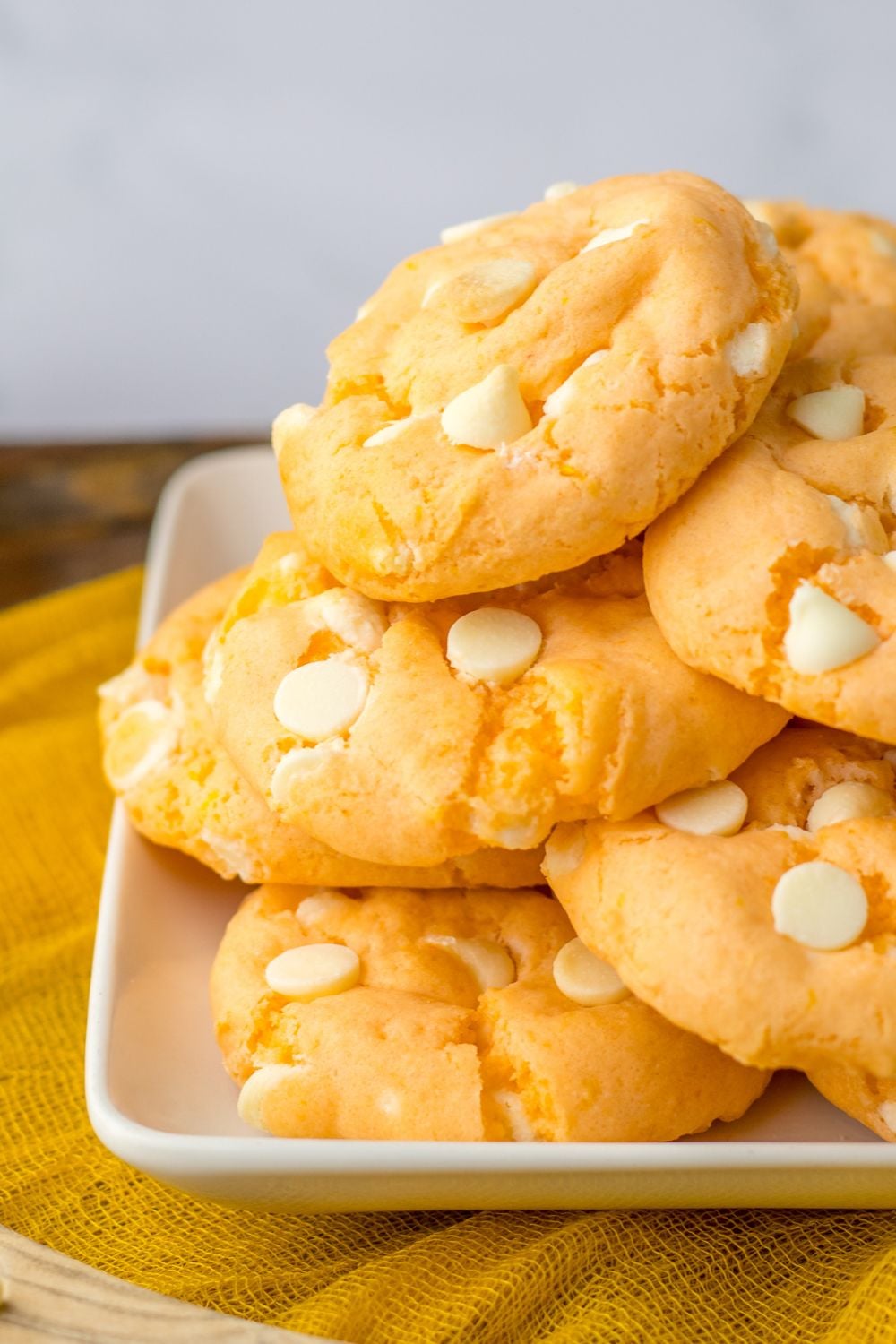 side view of orange cookies on a plate