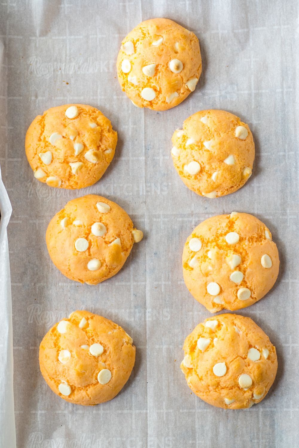 overhead shot of cooked orange cookies on a baking sheet