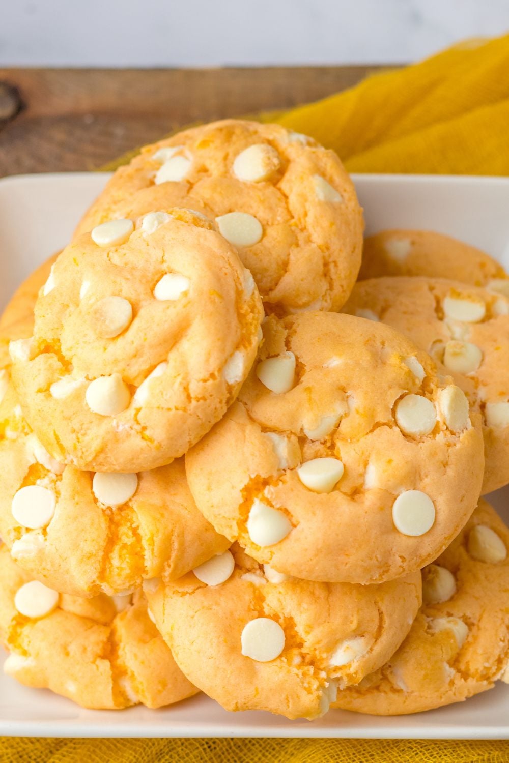orange cookies on a tray stacked on top of each other