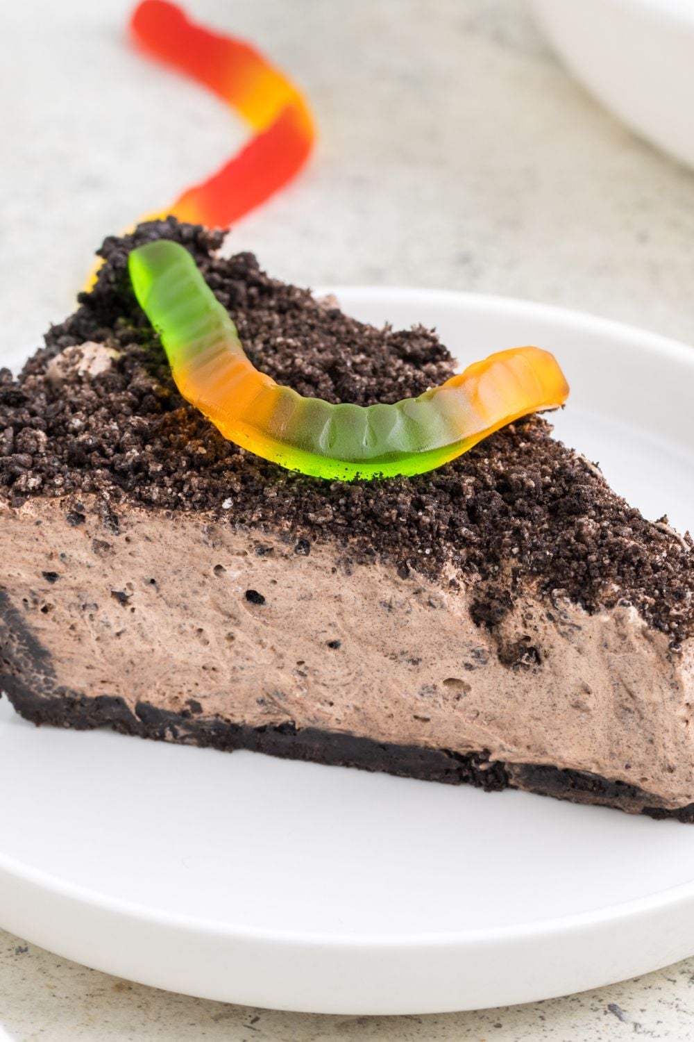 dirt pie on plate with a gummy worm on top
