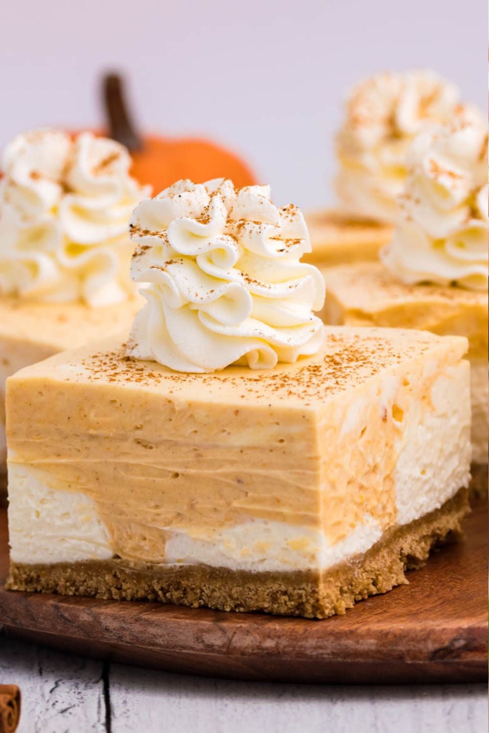 philadelphia cream cheese pumpkin cheesecake bars on table
