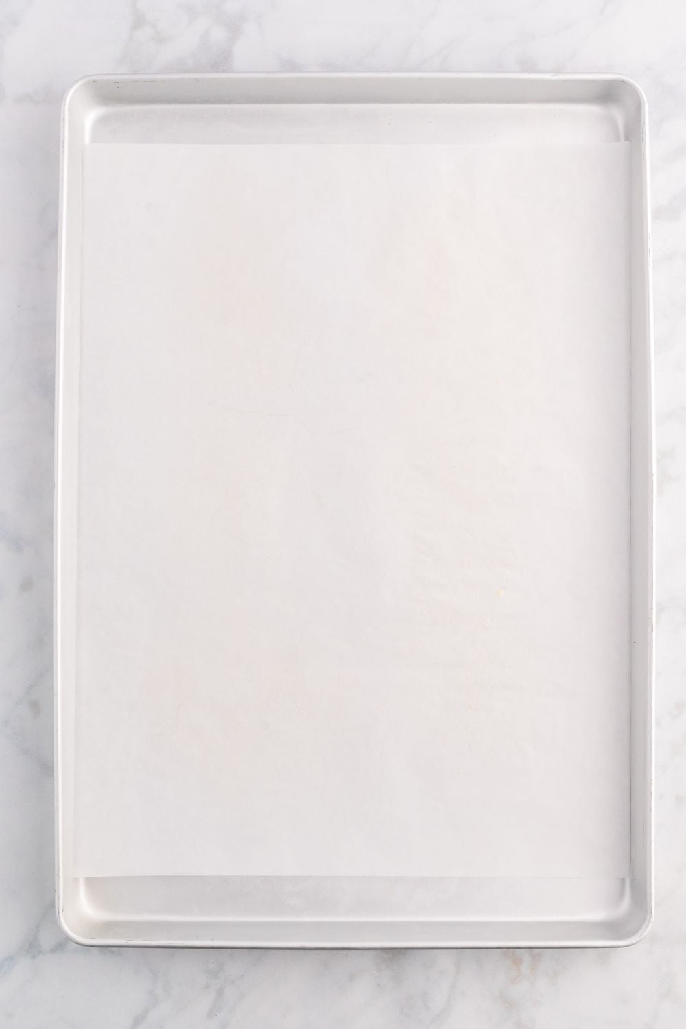 sheet pan with parchment paper on it