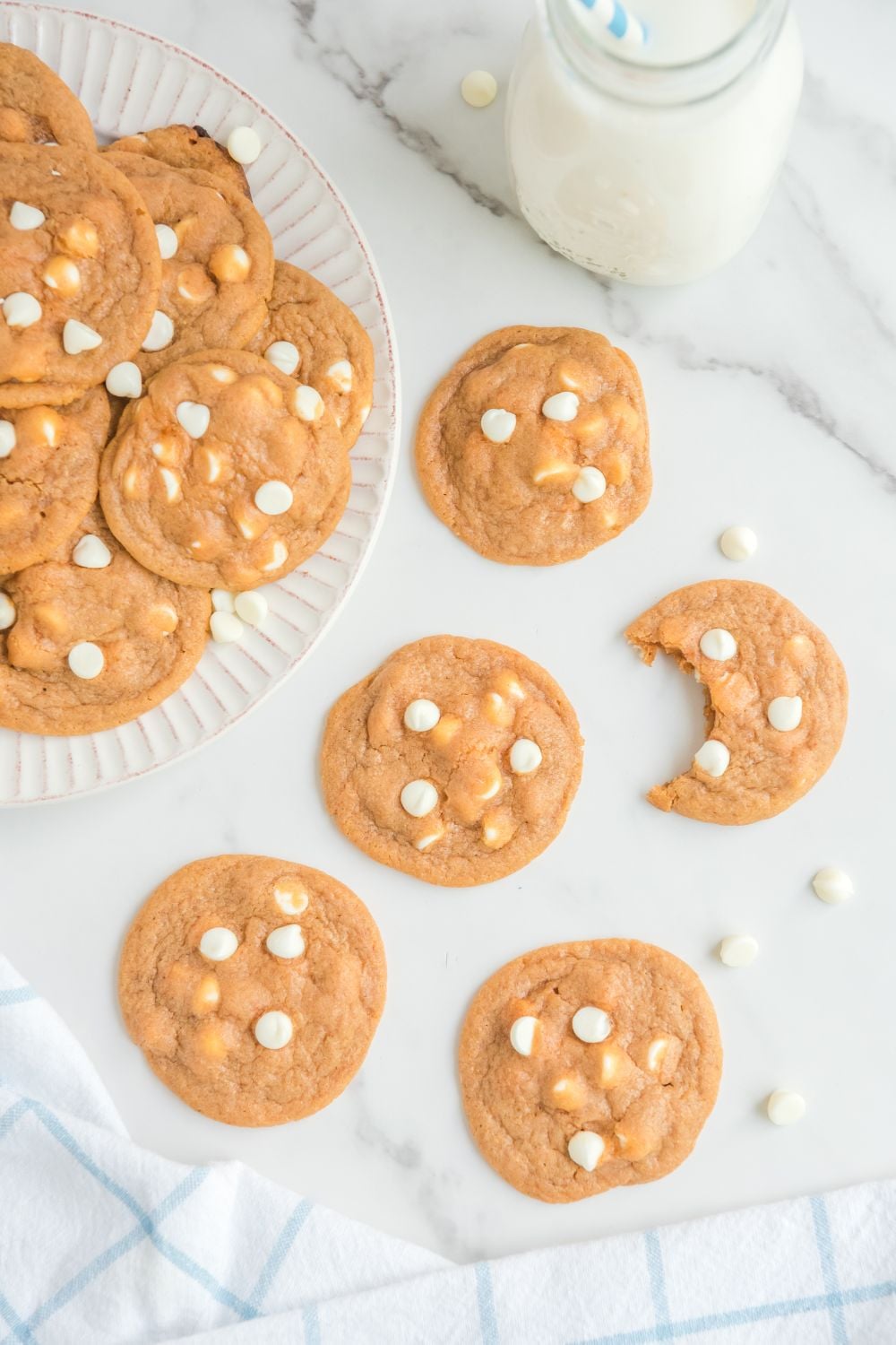 cookies on table with one cookie with a bite taken out