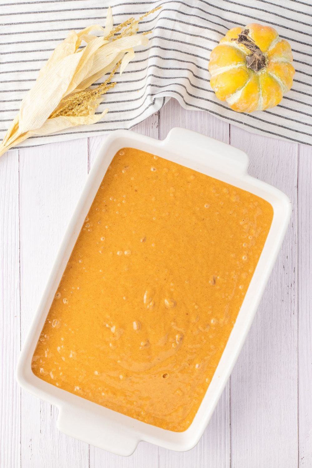 pumpkin cake batter in a baking pan