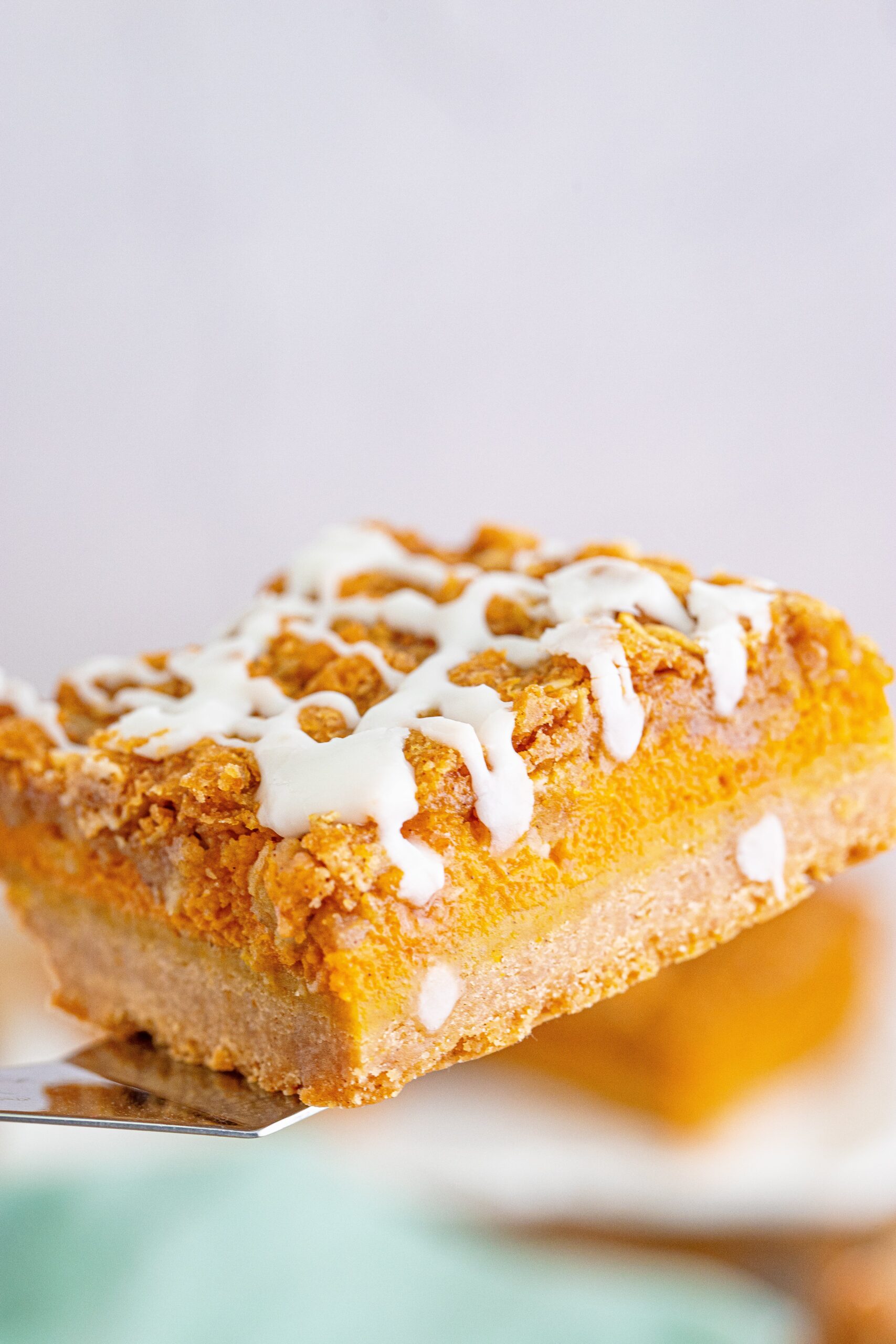Pumpkin Streusel Bars on a spatula aboe the pan