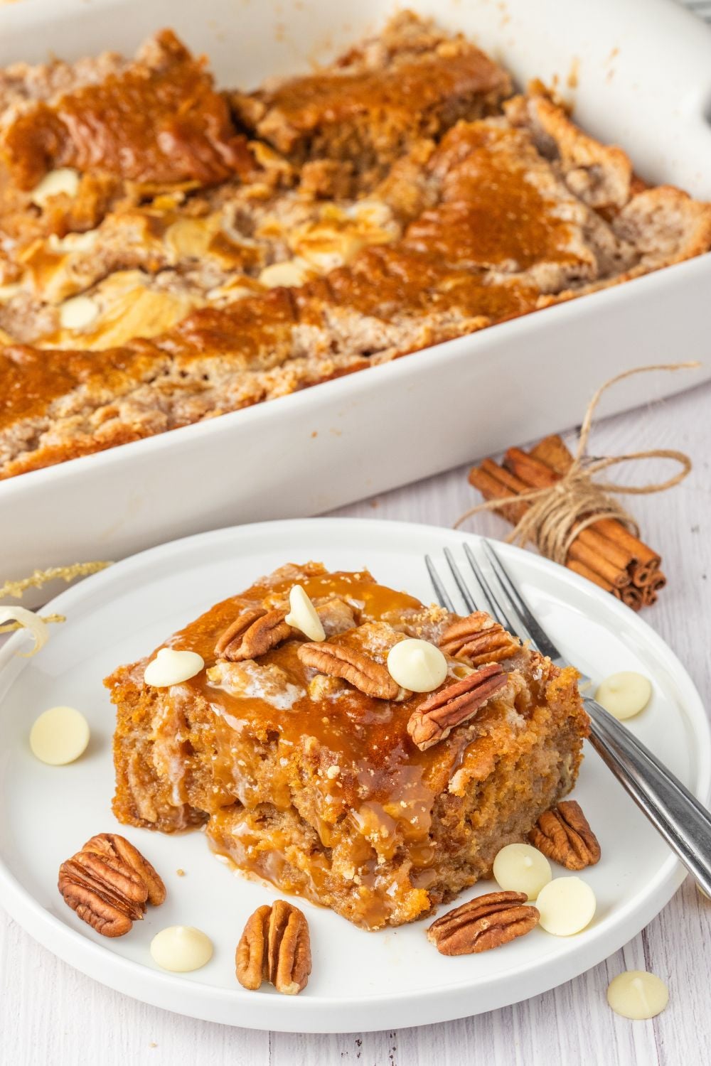 pumpkin cake on plate with nuts around it