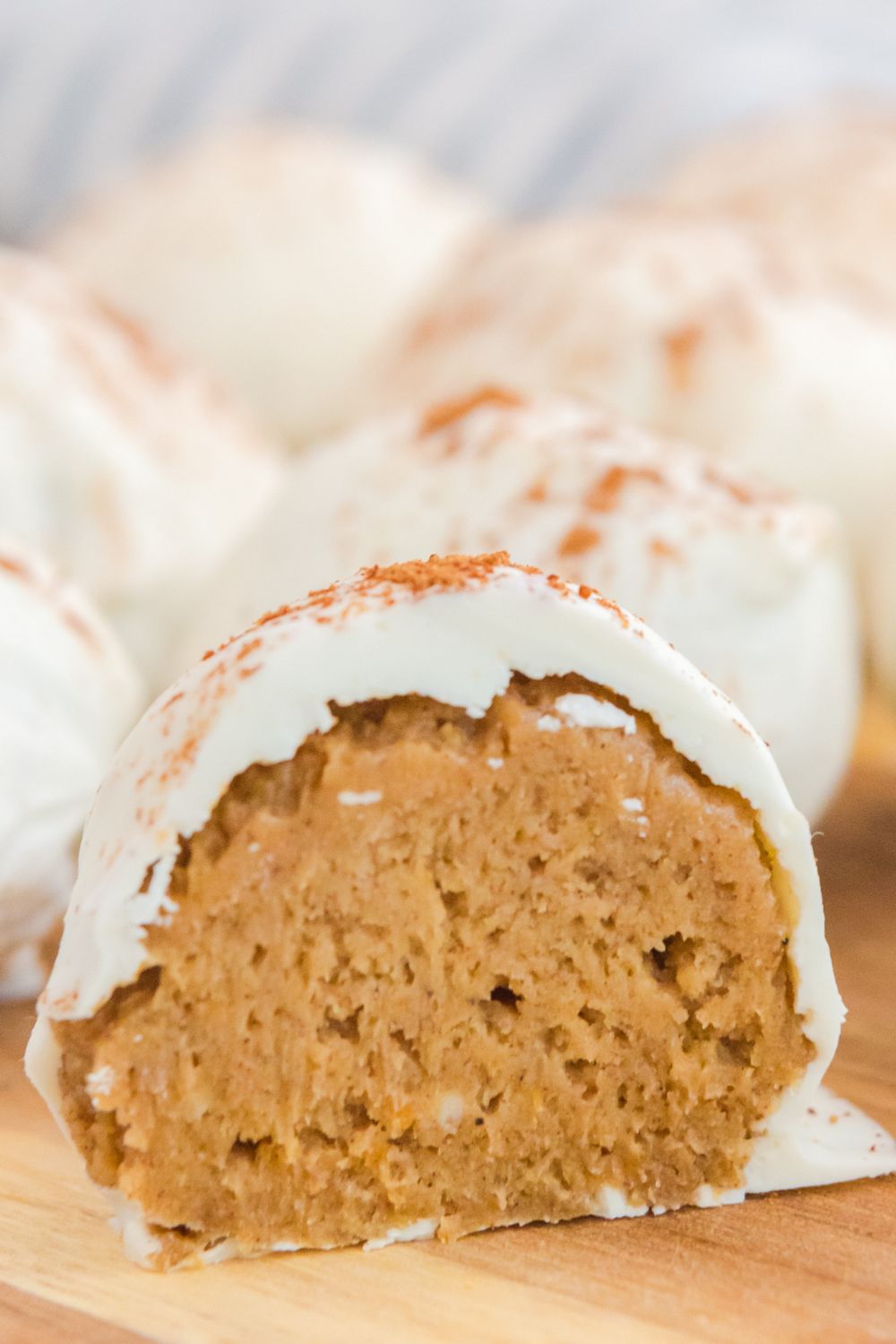 pumpkin spice ball cut in half placed on wooden board