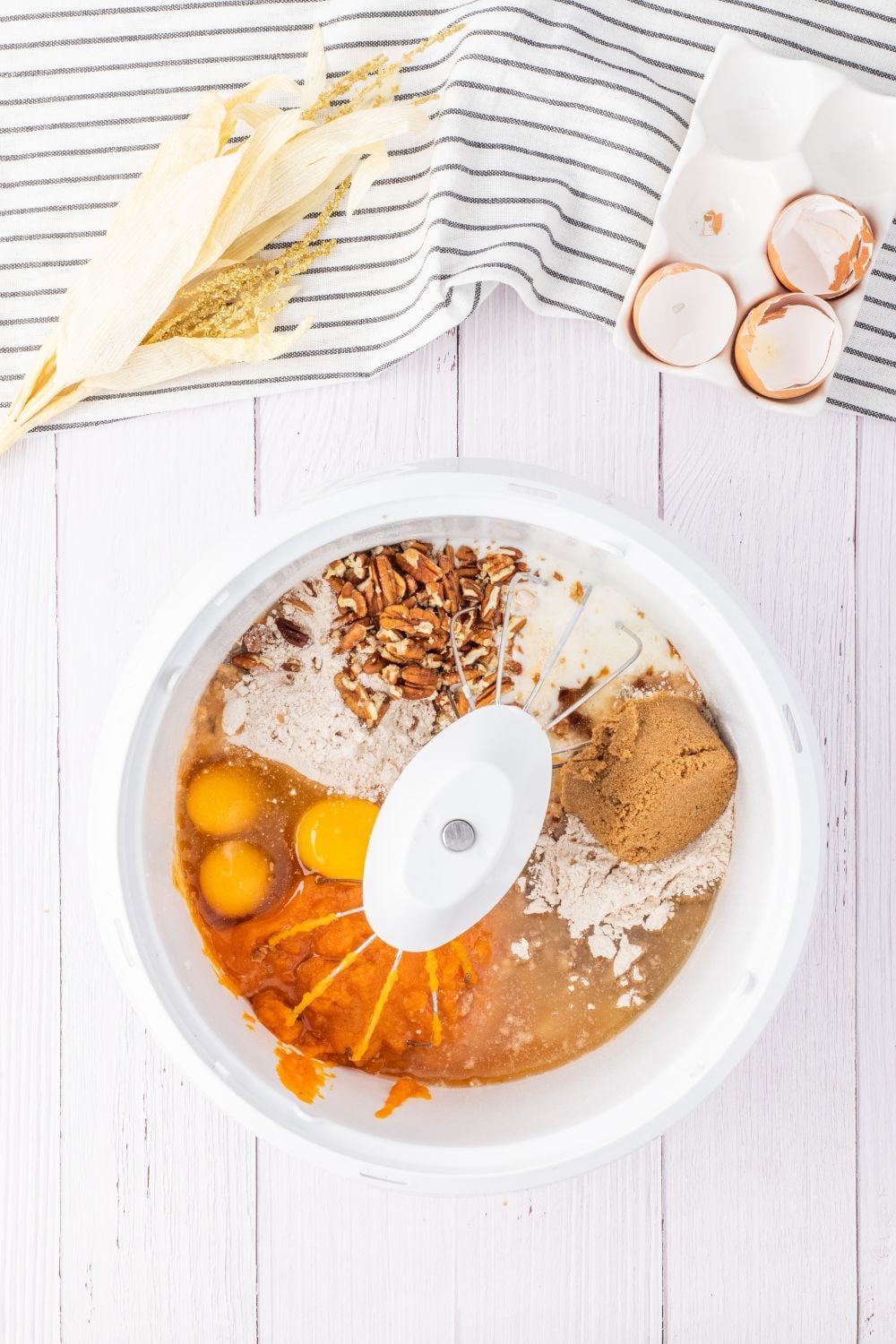 ingredients for a pumpkin cake in mixer on table
