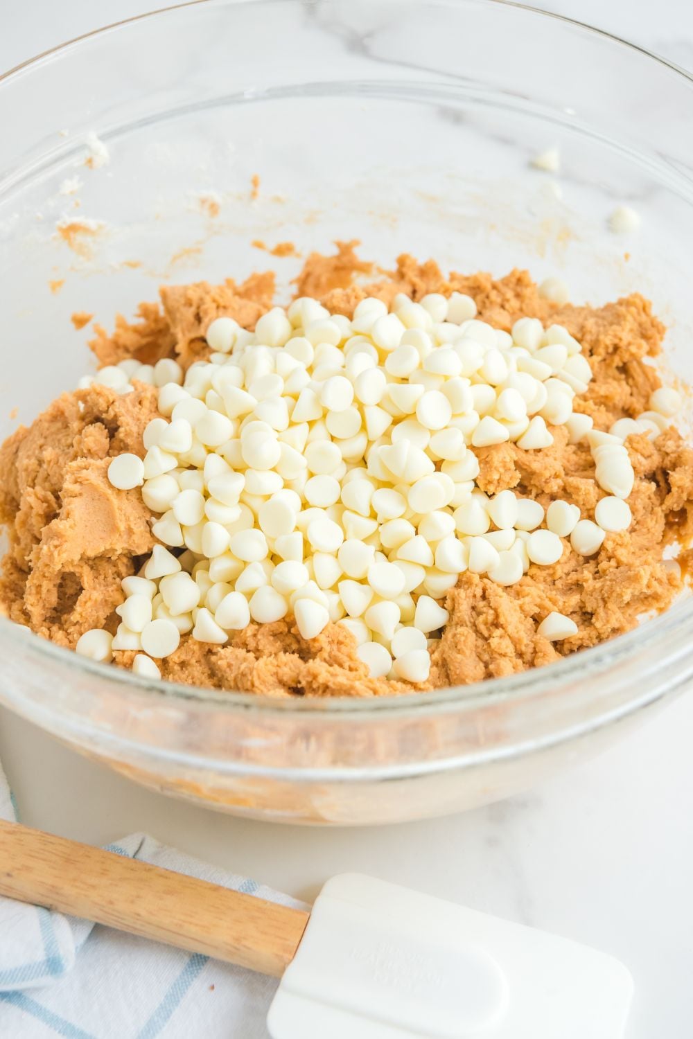 white chocolate chips on top of the pumpkin cookie dough