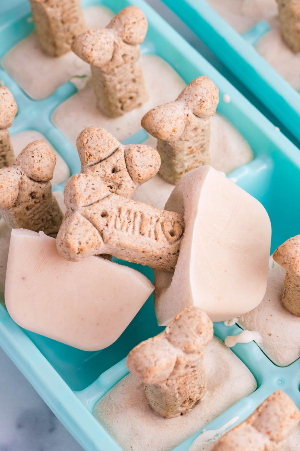 ice cream in a ice cube tray with cookie on it