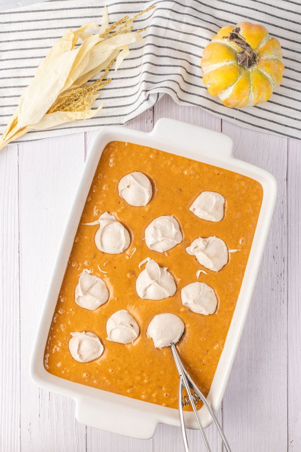dollops of cream cheese mixture in a cake