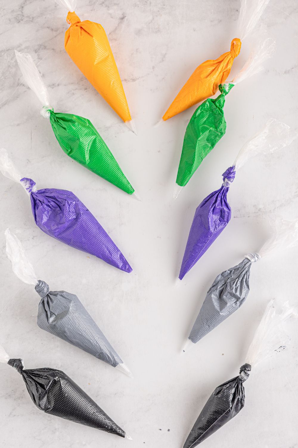 royal icing in piping bags on table 