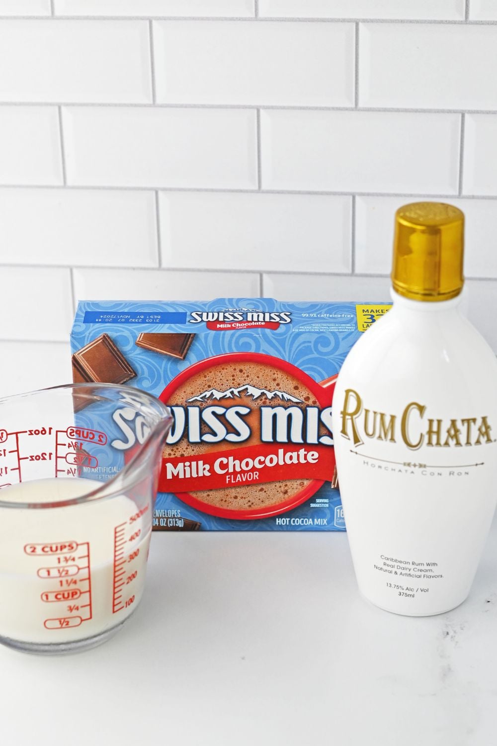 ingredients for rumchata hot chocolate on a white table